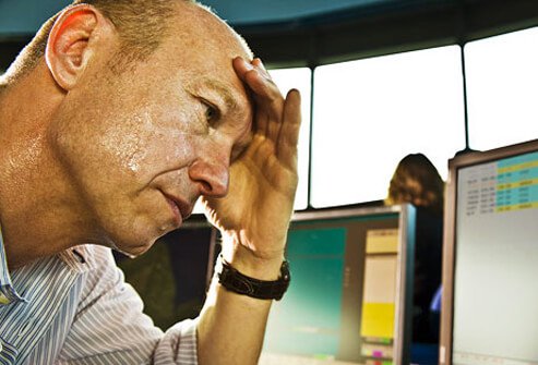 hyperhidrosis-what-makes-you-sweat-s4-photo-of-stressed-man-sweating-at-desk