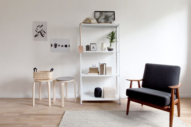 Không gian phòng đơn giản, được trang trí bằng tranh tường tinh tế. Giá sách và kệ đựng vật dụng cá nhân kết hợp gam màu lạnh của căn nhà.
