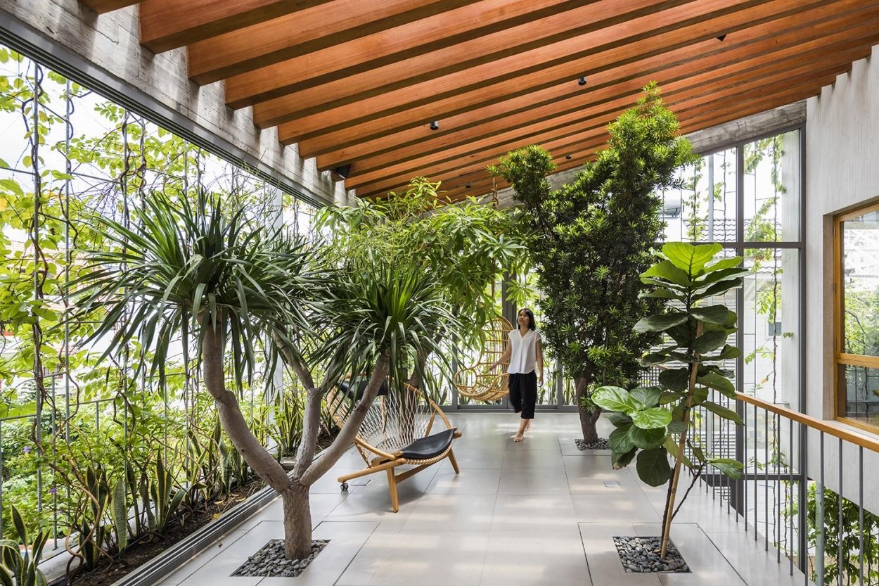 Hành lang của ngôi nhà này được thiết kế như một lối đi công viên thu nhỏ với xích đu, ghế ngồi vãn cảnh, uống trà và vô vàn cây xanh.