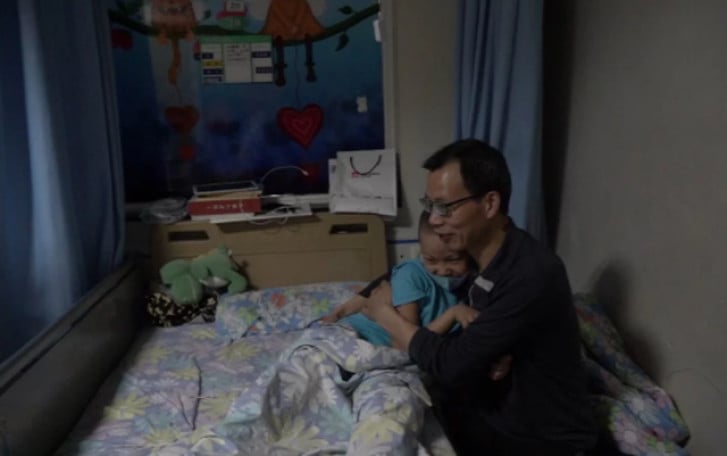 Liu Wei ôm con trai Liu Xuntao tại Khoa Ung thư trẻ em, Bệnh viện Nhân dân tỉnh Tứ Xuyên. Ảnh: SCMP
