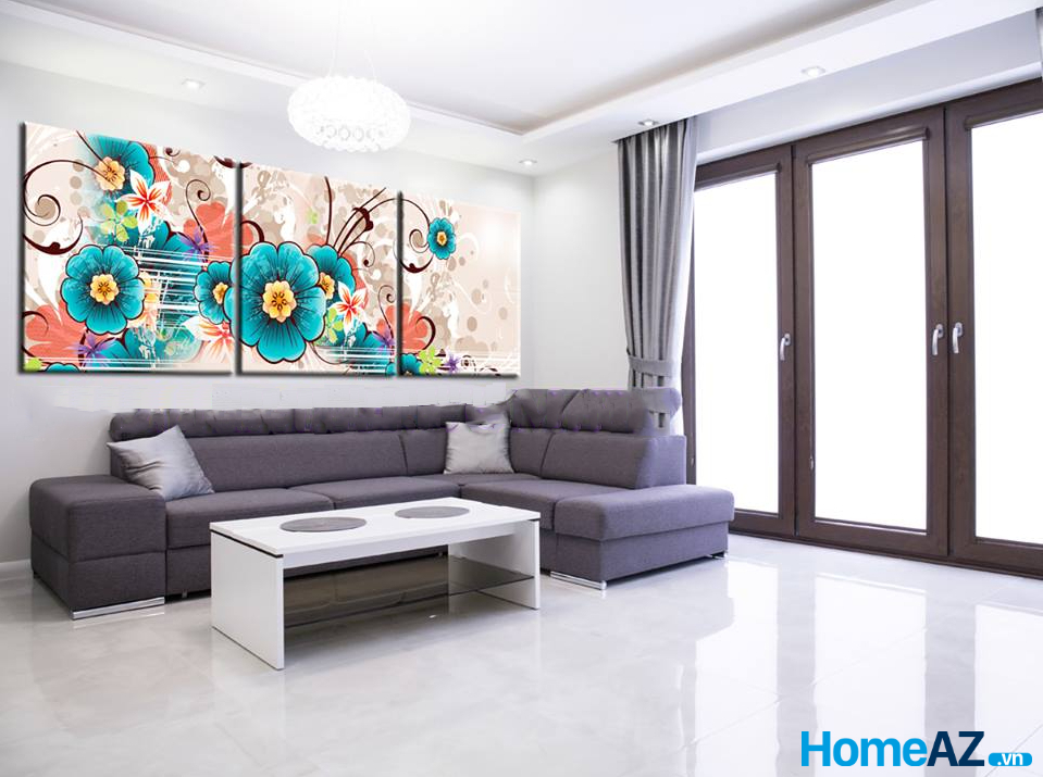 Bộ tranh treo tường màu sắc tươi sáng giúp làm căn phòng khách tối giản thêm tươi vui hơn