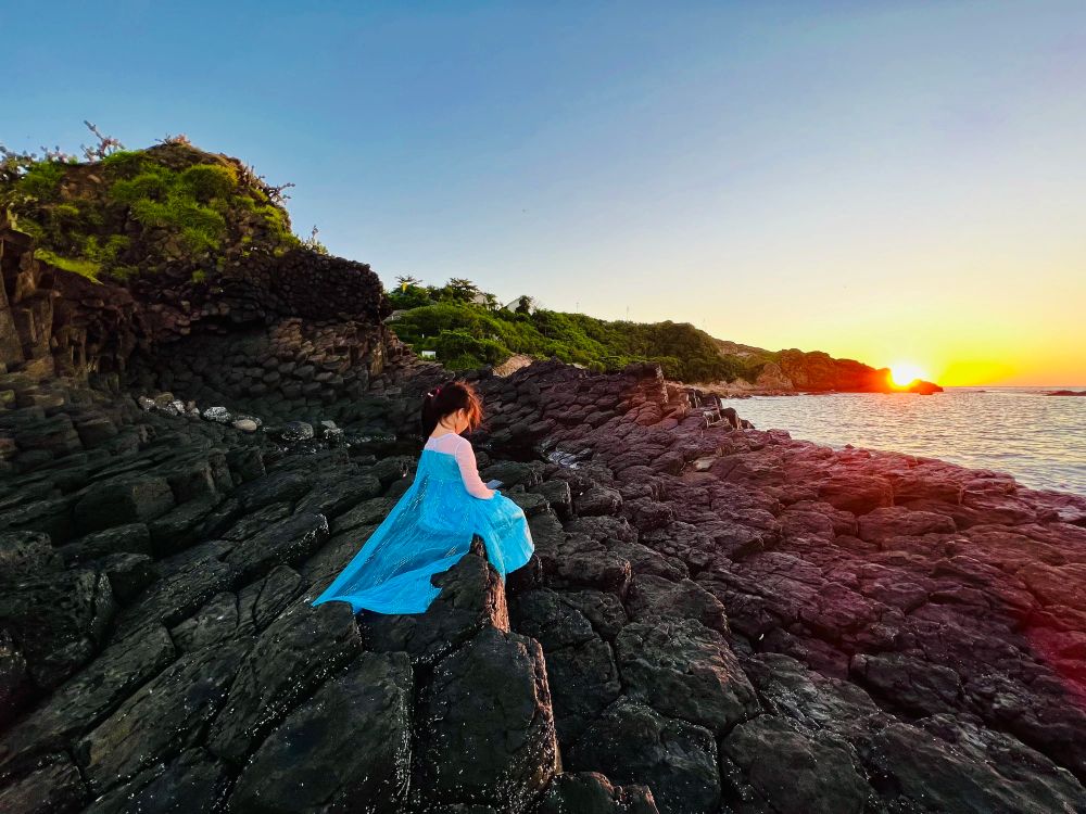 Cháu gái ngắm hoàng hôn trên biển