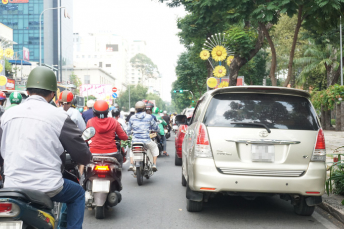 Ôtô đậu dưới lòng đường Nguyễn Thị Minh Khai khiến các phương tiện di chuyển qua đây rất khó khăn