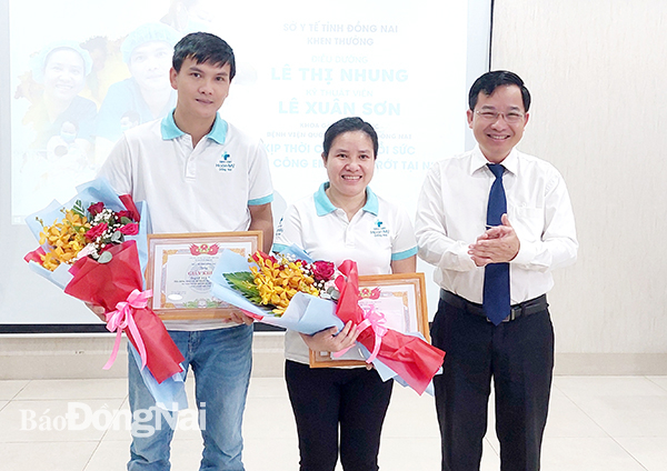 Phó giám đốc phụ trách Sở Y tế Lê Quang Trung khen thưởng vợ chồng điều dưỡng Lê Thị Nhung, Lê Xuân Sơn.