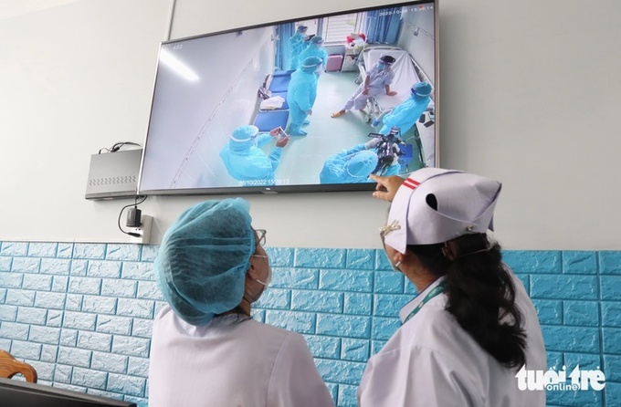 Nhân viên y tế Bệnh viện Bệnh nhiệt đới (TP.HCM) giám sát ca bệnh đậu mùa khỉ đầu tiên từng điều trị tại bệnh viện vào tháng 10-2022 - Ảnh: XUÂN MAI