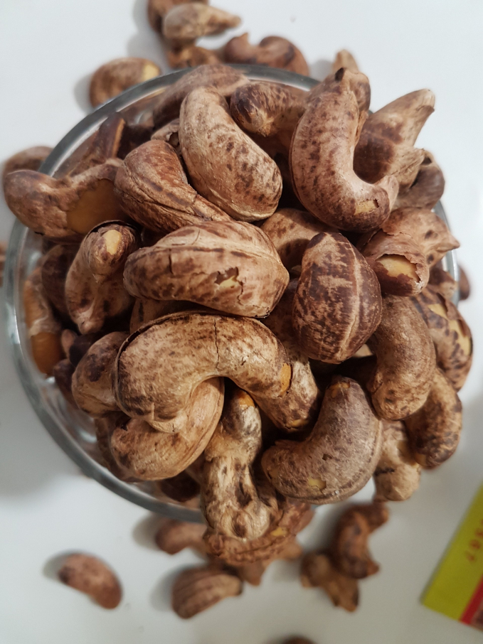 Ẩn sau lớp vỏ là những hạt điều tươi rang củi nhân vàng ruộm, cắn vào giòn tan trong miệng, thơm nức mũi.