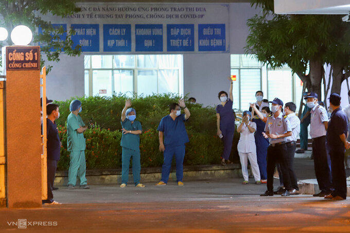 Nhiều bác sĩ vẫy tay khi cánh cổng chính của bệnh viện ở 122 Hải Phòng được mở. Ảnh: Nguyễn Đông.