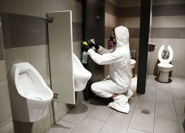 Nhân viên y tế làm việc trong một nhà vệ sinh ở Toronto, Canada. Ảnh: Bloomberg