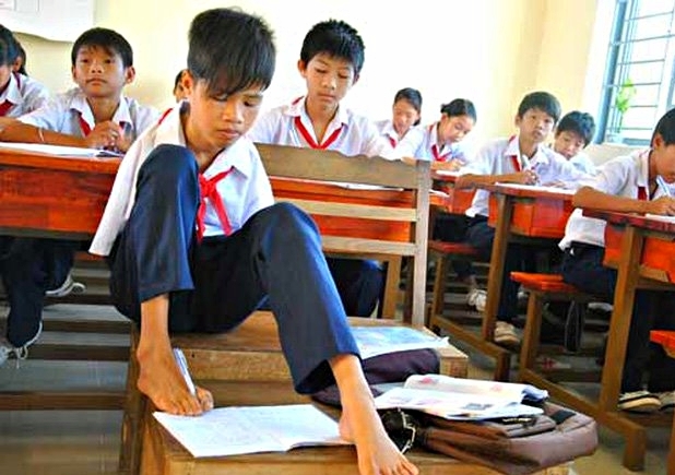 Hồ Hữu Hạnh khiến các học sinh khác ngỡ ngàng trước kỹ năng viết bằng chân. (Ảnh: Nhân vật cung cấp).