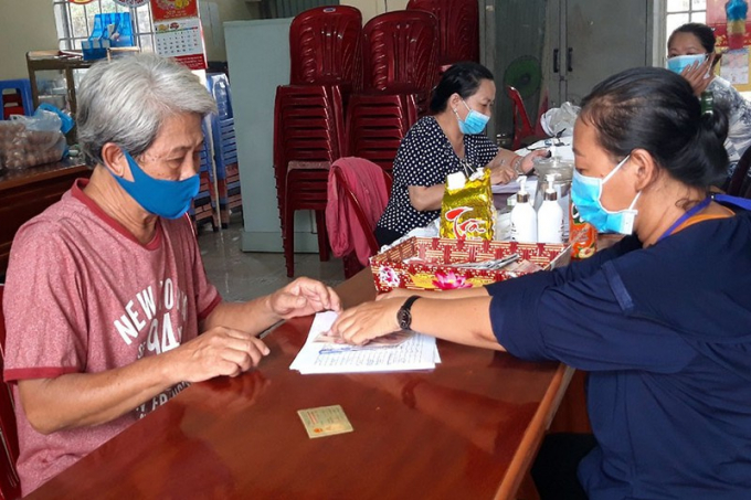 Người dân ký nhận tiền hỗ trợ do ảnh hưởng của dịch COVID-19tại phường Quang Vinh (TP Biên Hòa). Ảnh: VH
