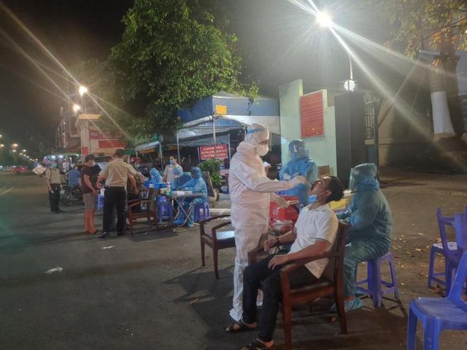 Lấy mẫu xét nghiệm Covid-19 cho các tiểu thương đang buôn bán tại chợ đầu mối nông sản Thủ Đức ẢNH: HCDC
