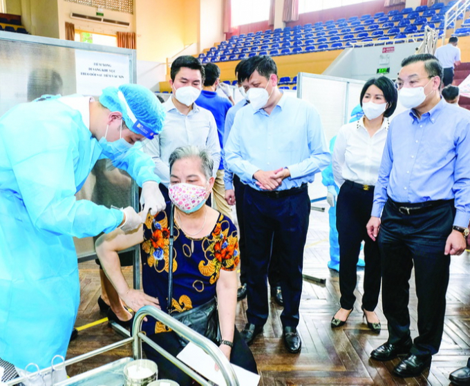 Bộ trưởng Bộ Y tế Nguyễn Thanh Long (đứng giữa) kiểm tra công tác tiêm chủng vaccine phòng COVID-19 tại Hà Nội. Ảnh: Trần Minh